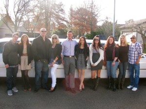 group of people in front of a rental limo